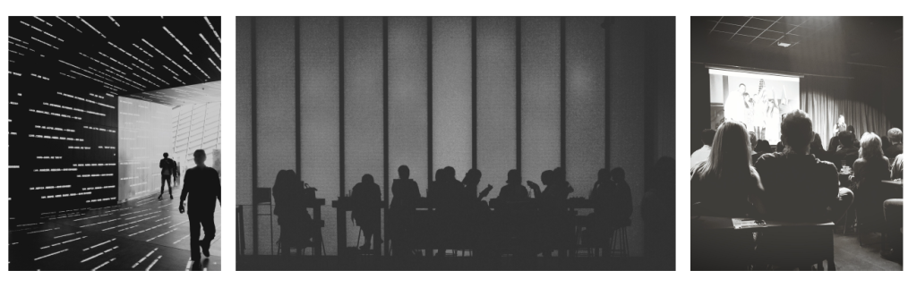 People moving through data-filled spaces, sitting in shadowed discussion, and watching a presentation—work, collaboration, and observation in modern systems.